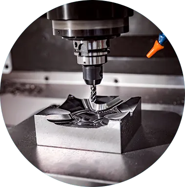End mill cutting a contoured pocket into a steel block