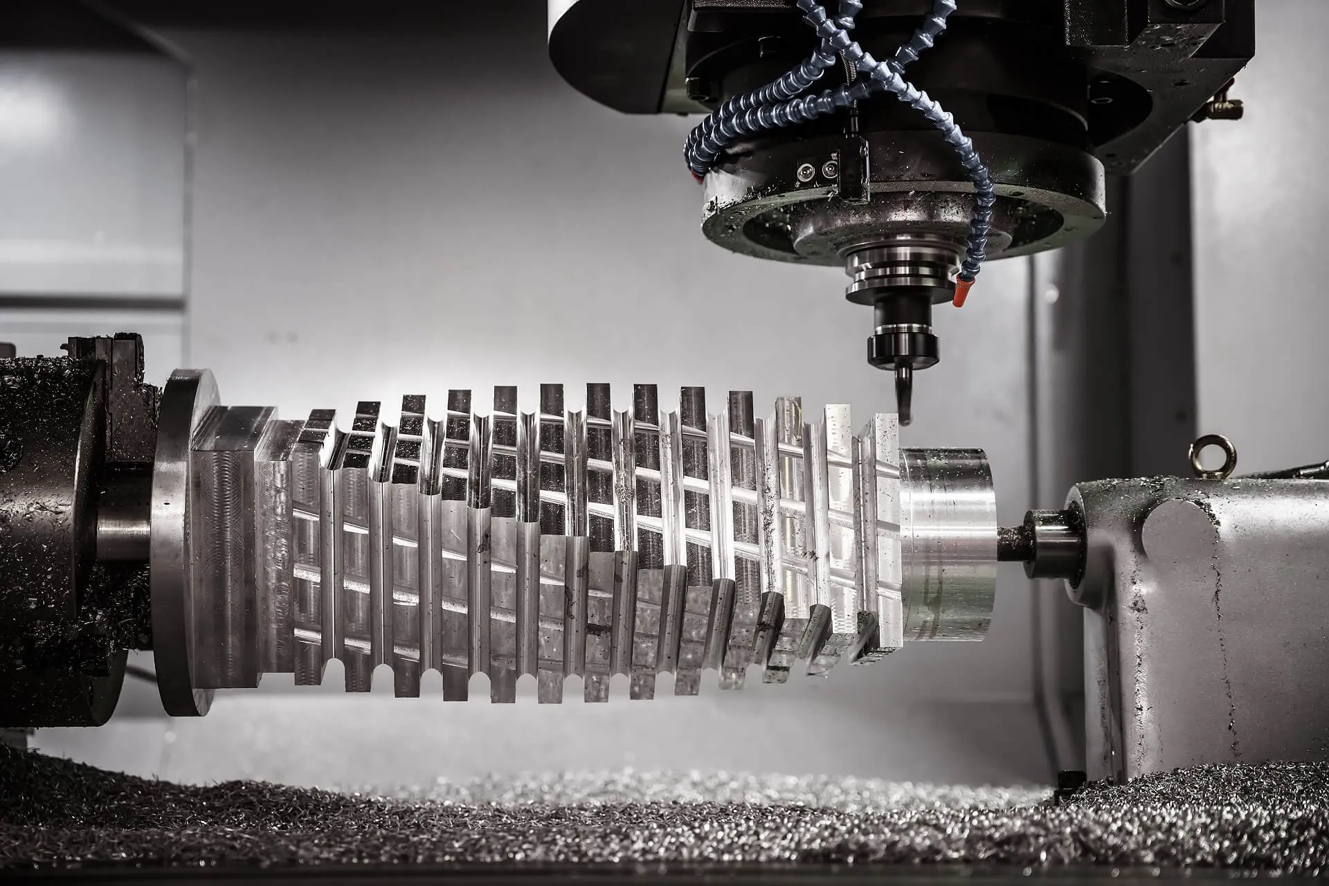 CNC milling machine cutting a metal part, chips clearing the cut