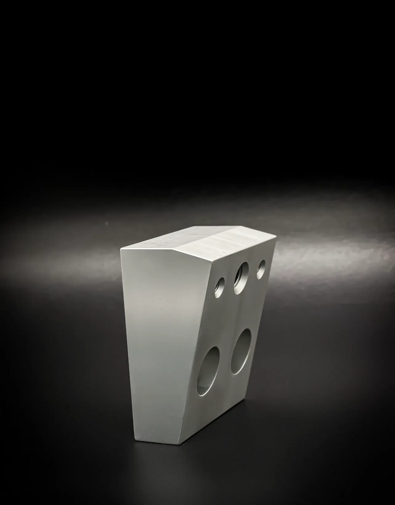Machined aluminium block with drilled bores, produced at Krato Structures